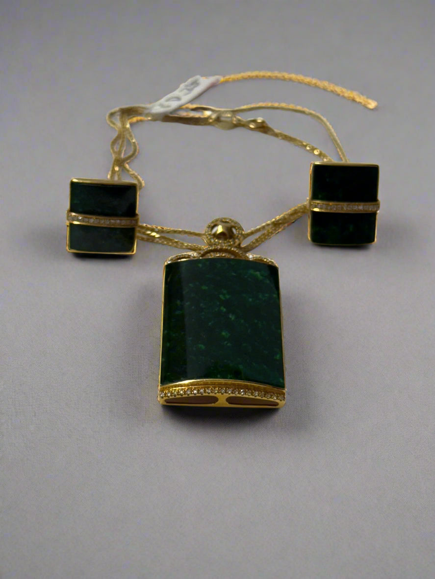 jade set of earing and pendant with 18k gold and diamond on it.