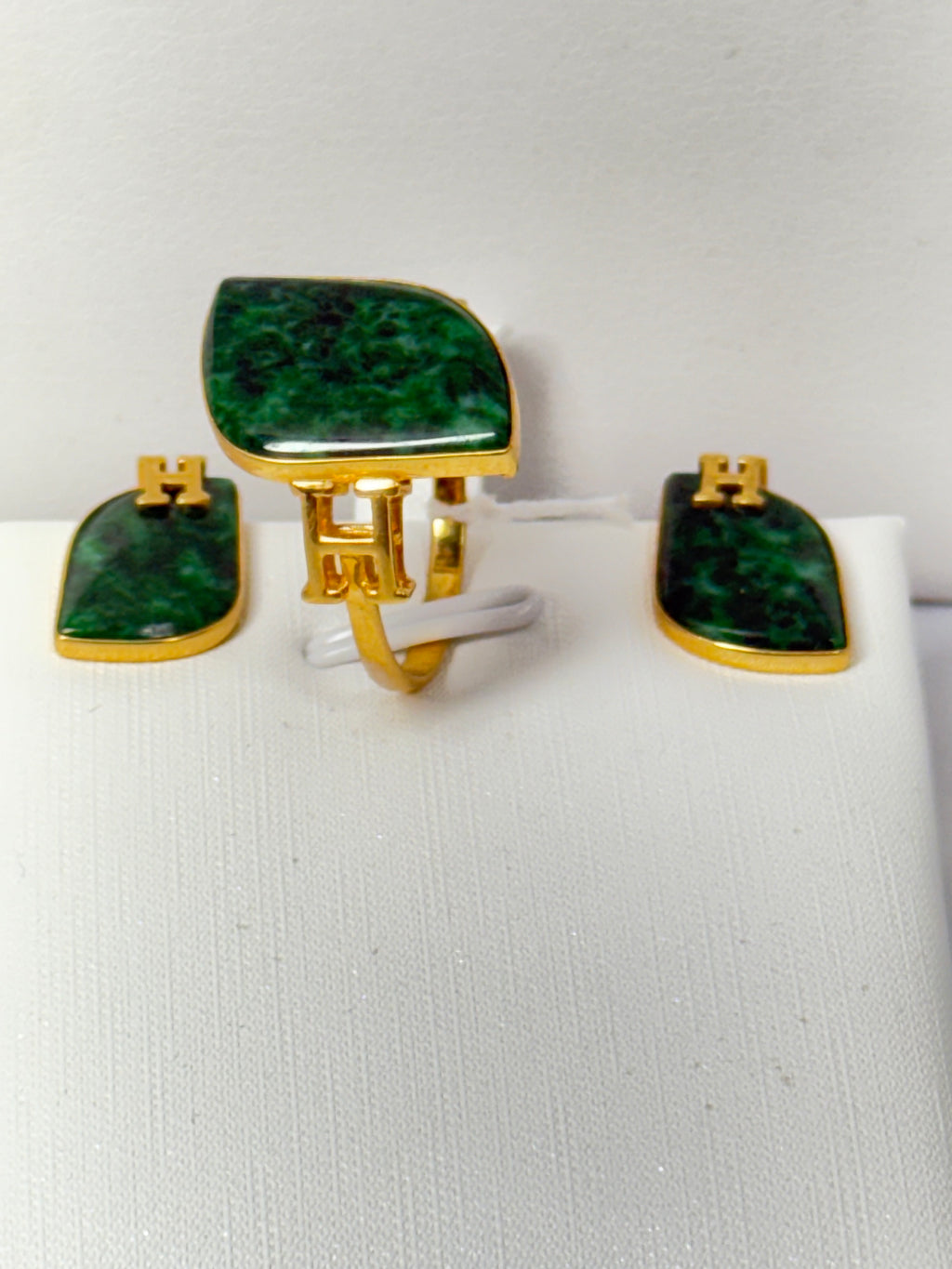 Green jade on a set of 18 karat gold and diamond ring and earrings